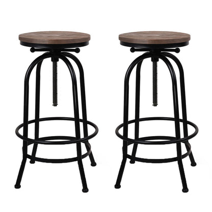 Two bar stools with wooden seats and black metal frames on a white background