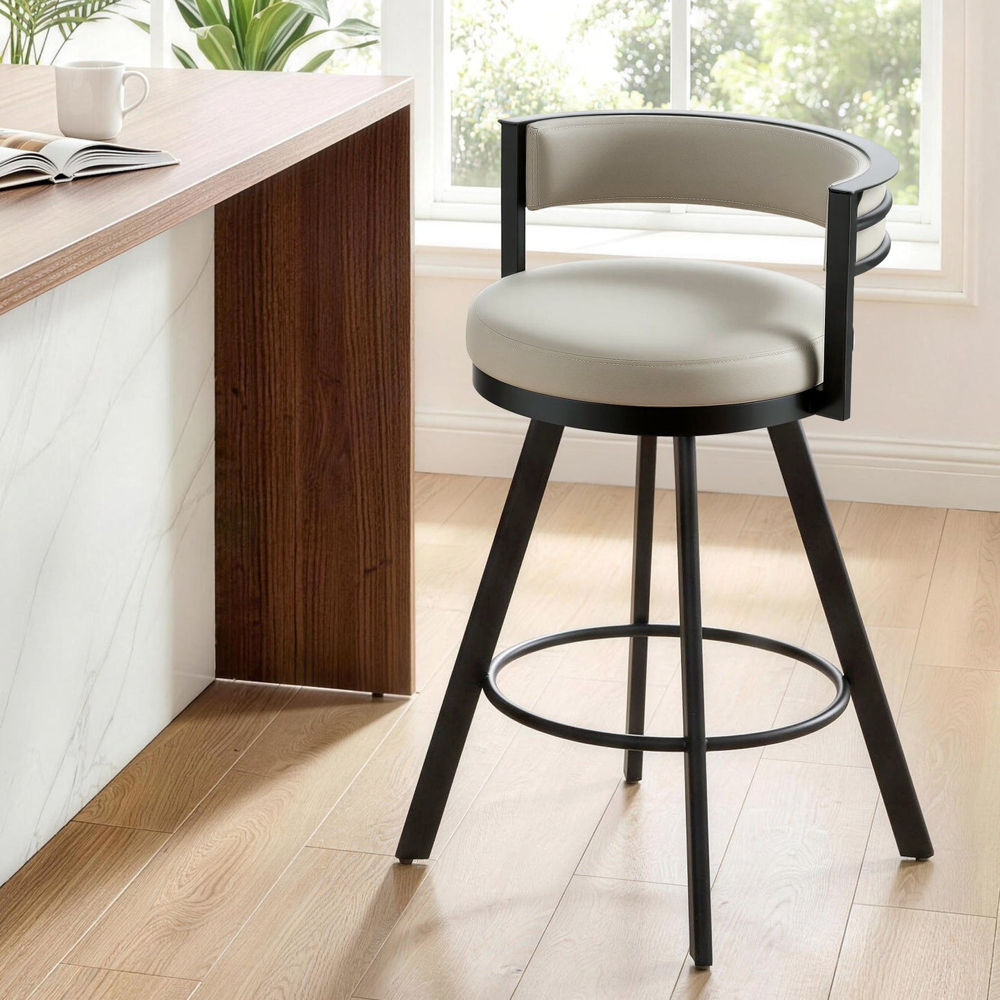Bar stool with beige cushioned seat and black frame in a modern kitchen setting.