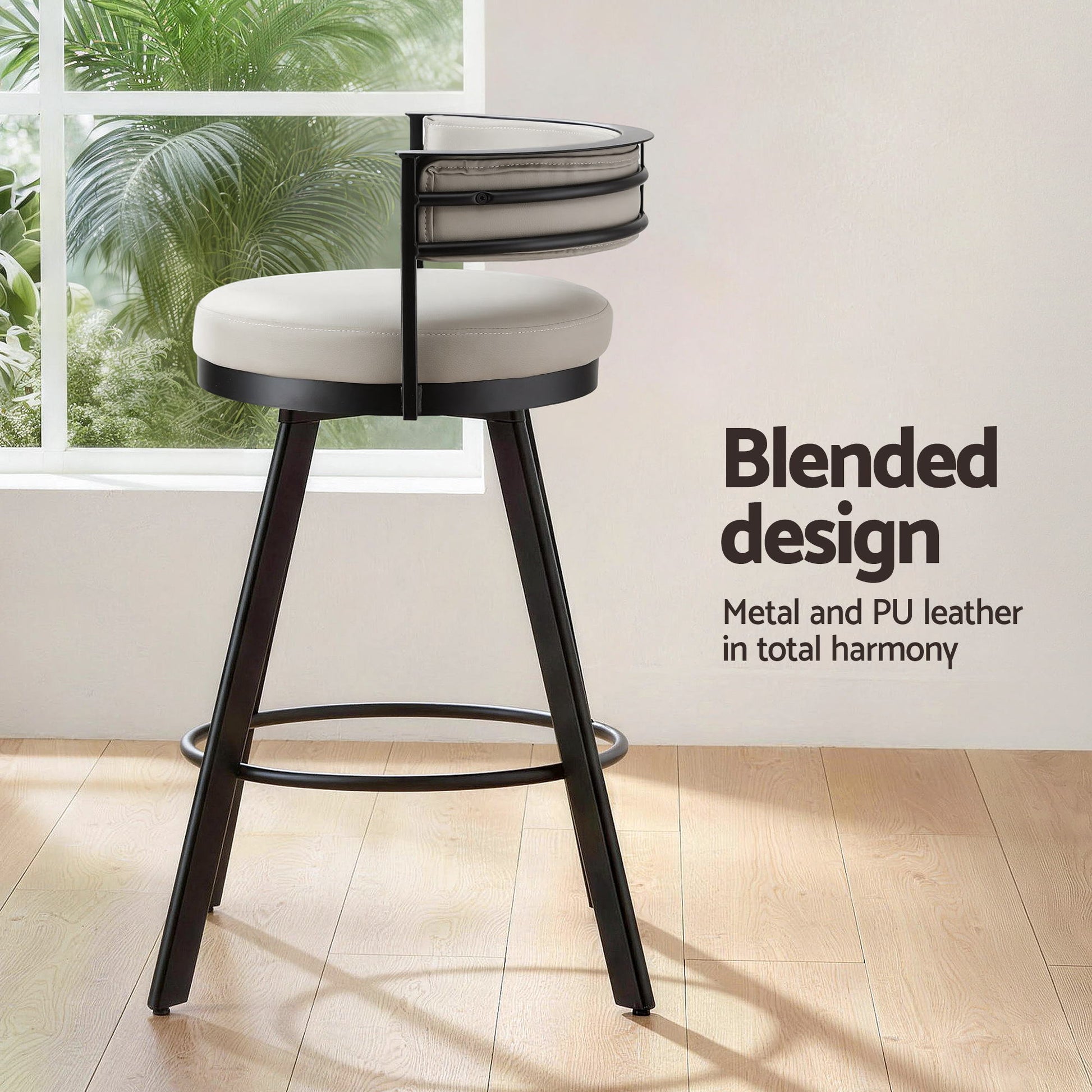 Bar stool with metal frame and white cushioned seat in a room with a window and plants.