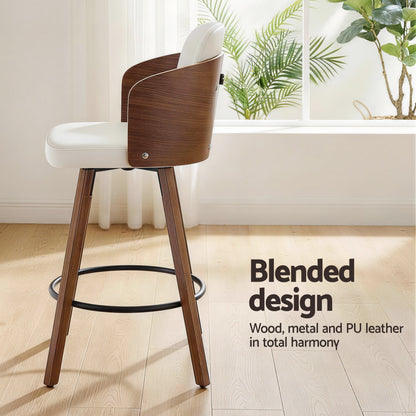 Wooden bar stool with white seat in a room with plants