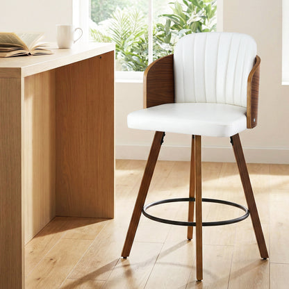 White bar stool with wooden legs in a bright room with a desk and plants.
