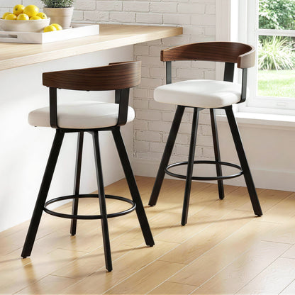 Two bar stools with white seats and black legs in a kitchen setting.