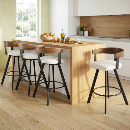 Modern kitchen with wooden island and stools, featuring a bowl of fruit and bread.