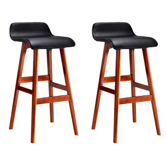 Two black leather bar stools with wooden legs on a white background