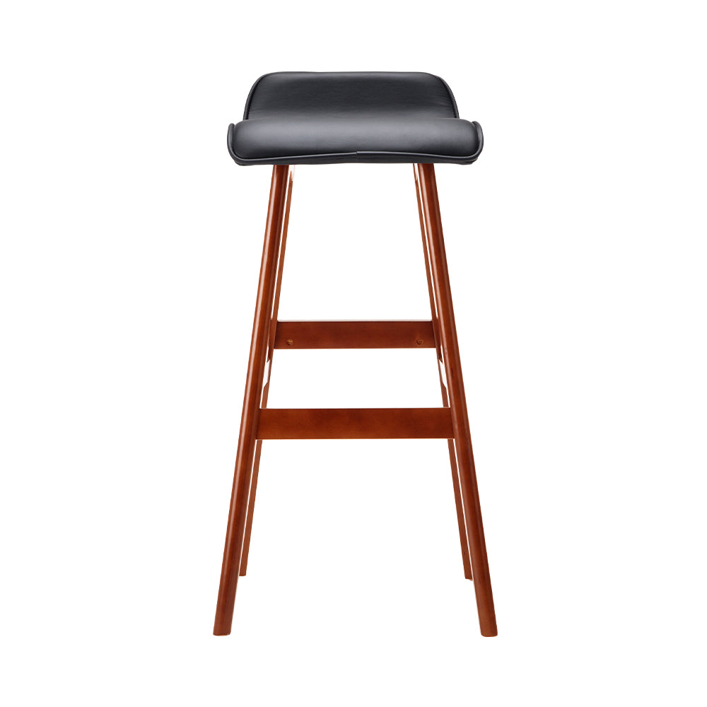 Bar stool with black seat and wooden legs on a white background
