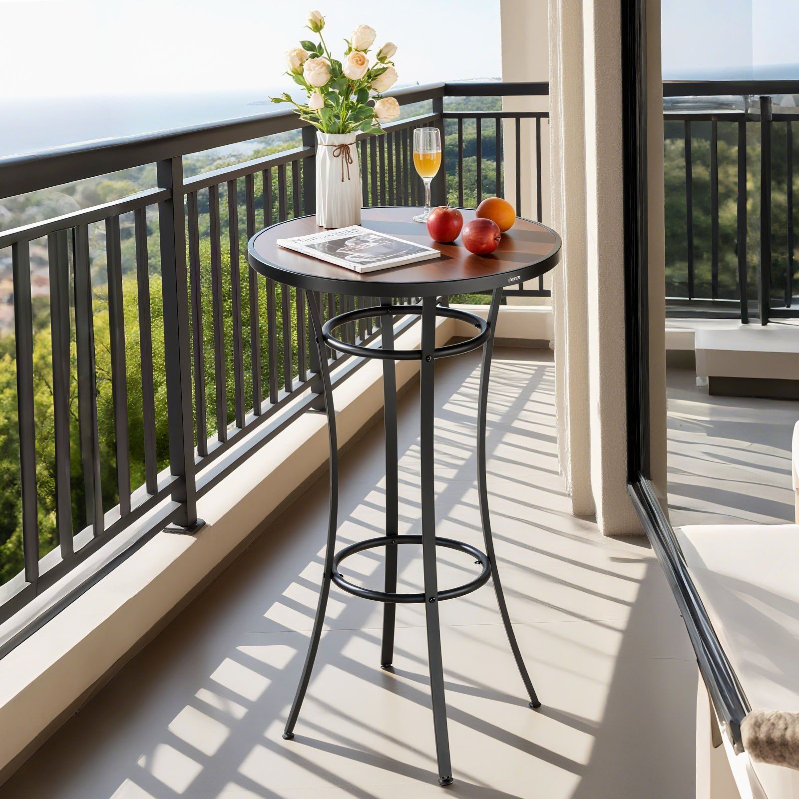 High table with a vase of flowers, fruit, and a newspaper on a balcony with a scenic view.
