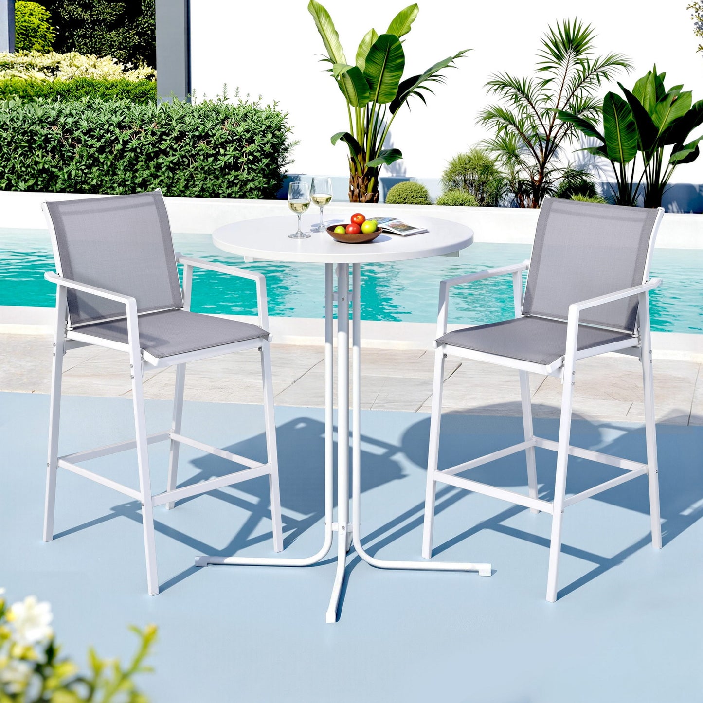 Outdoor patio set with two high chairs and a table by a pool