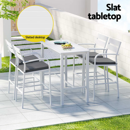 Outdoor dining set with white table and chairs on a patio, featuring a slatted tabletop.