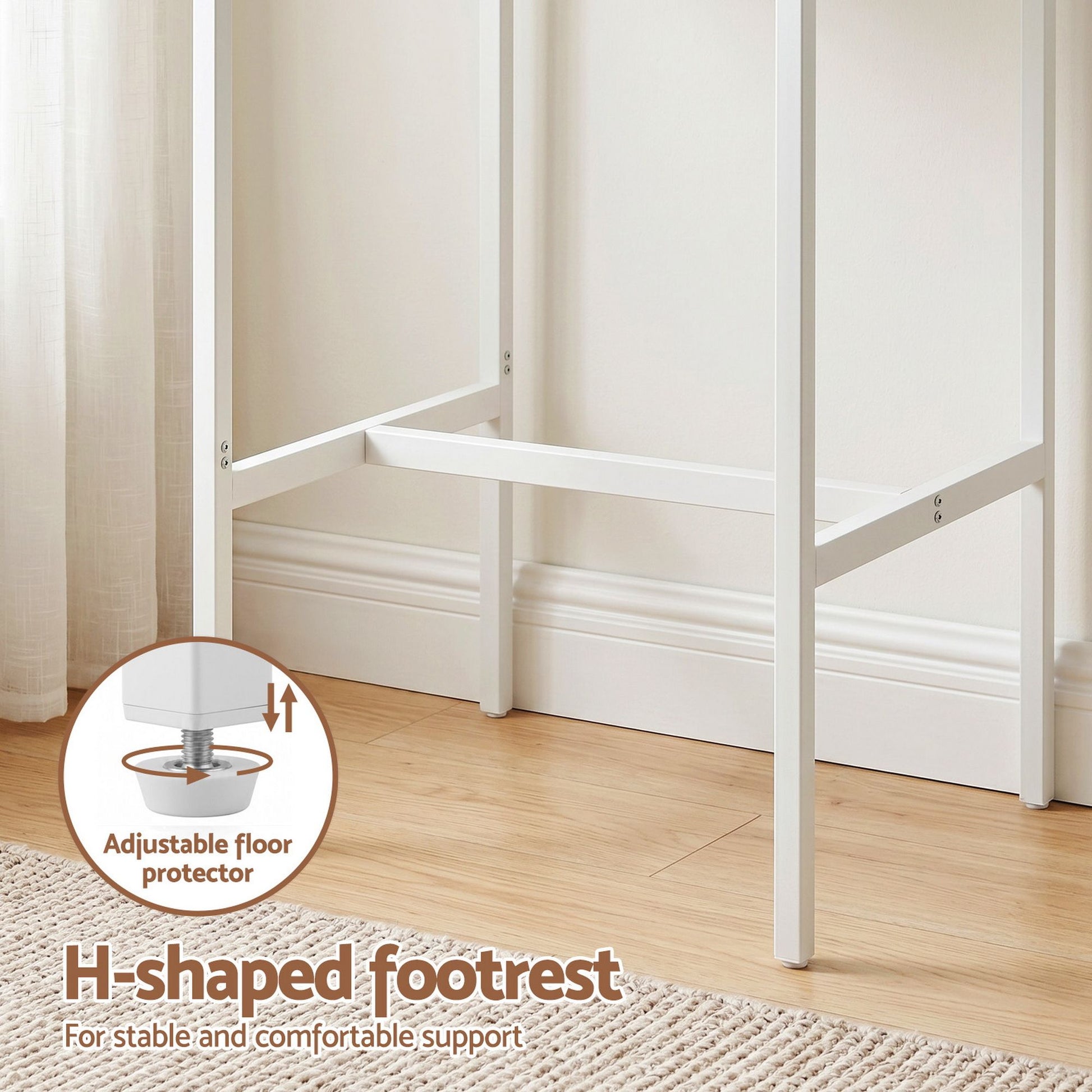 White H-shaped footrest with adjustable floor protector on a wooden floor.