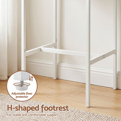 White H-shaped footrest with adjustable floor protector on a wooden floor.