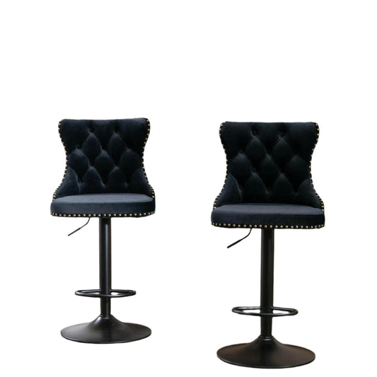 Two black tufted bar stools with white background.