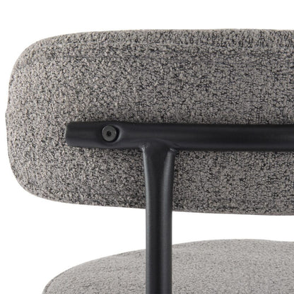 Close-up of a gray textured chair with a black metal base on a white background