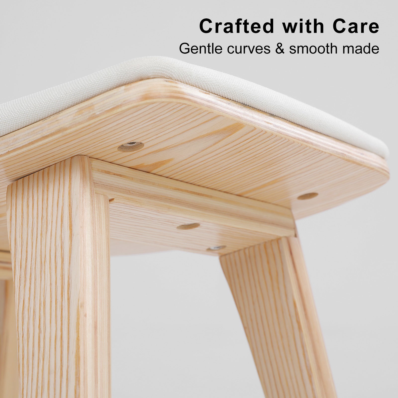 Wooden stool with a white cushioned seat on a light gray background, featuring text 'Crafted with Care' and 'Gentle curves & smooth made'.