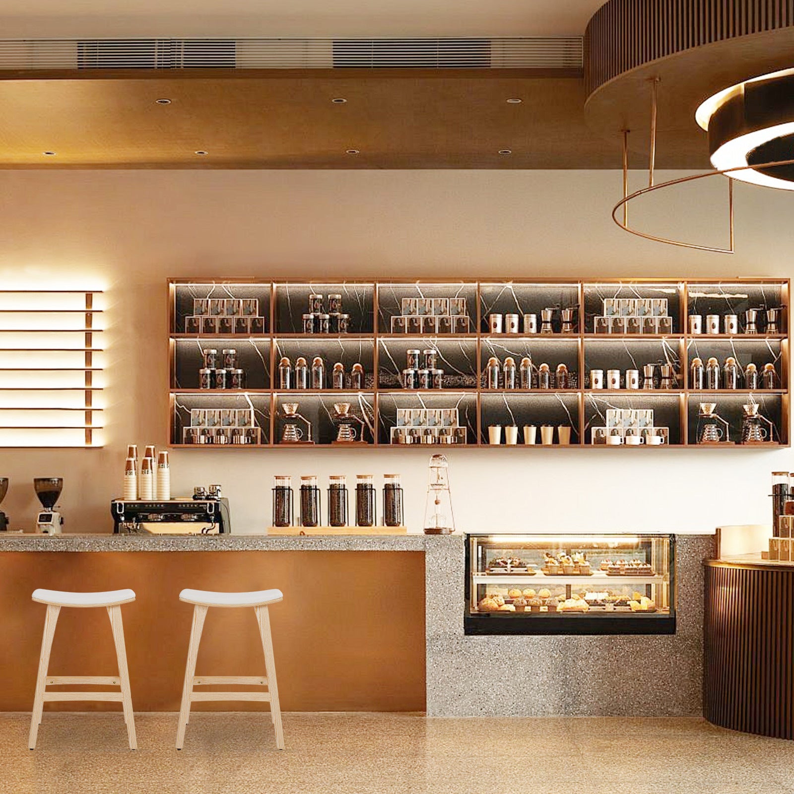 Modern cafe interior with shelves, counter, and stools.