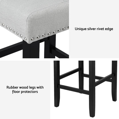 Grey cushioned stool with black legs and silver rivets on a white background