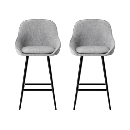 Two gray bar stools with black legs on a white background