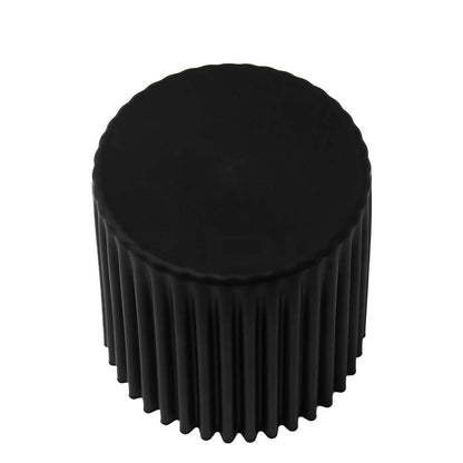 Black cylindrical object with ribbed texture on a white background