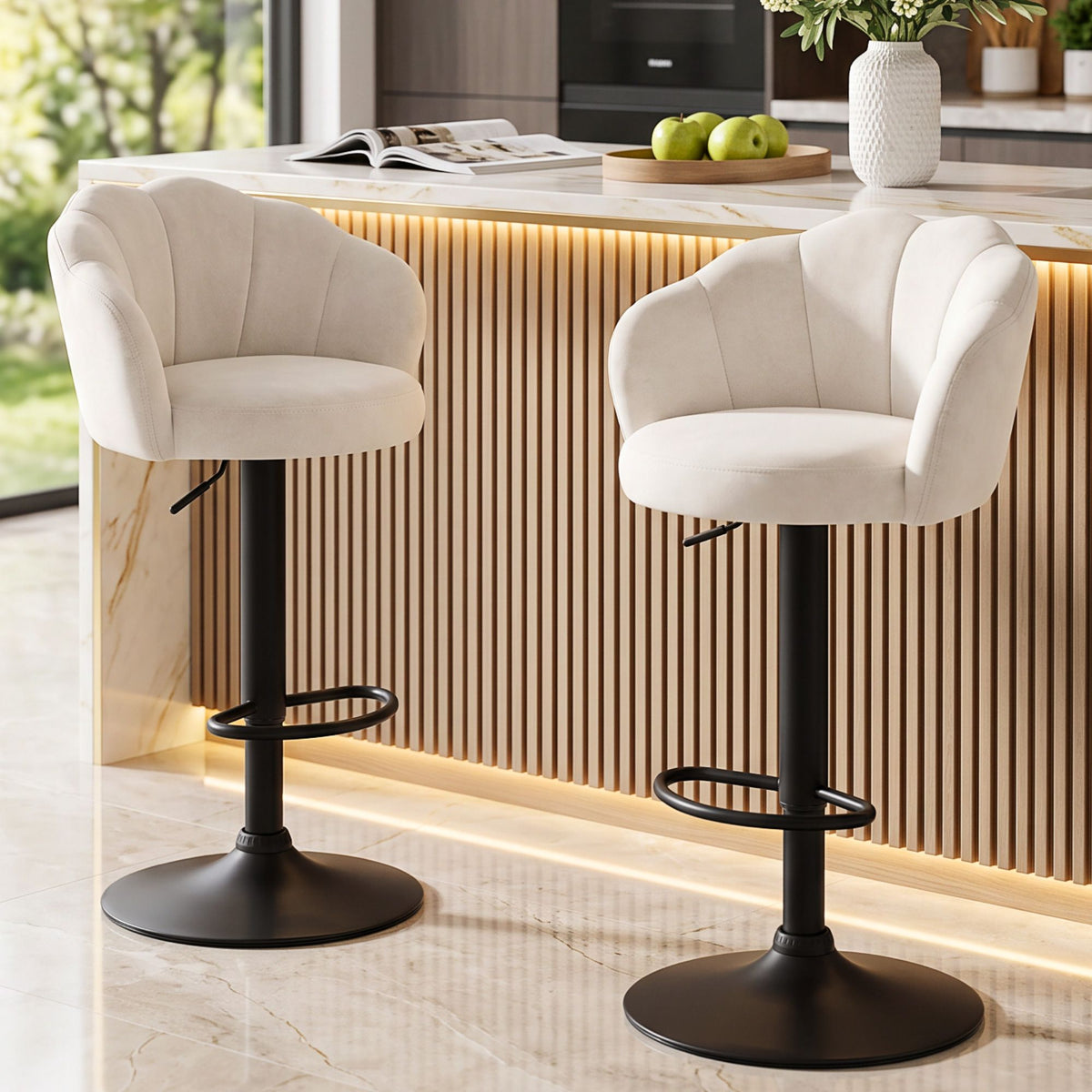 Two Emma ivory velvet swivel bar stools with black pedestal bases arranged around a contemporary kitchen island.
