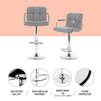 Two gray bar stools with chrome legs on a white background