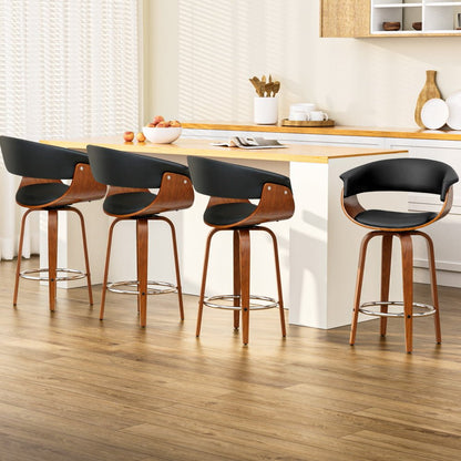 Set of 4 Jasper black PU leather swivel bar stools with walnut-finish timber frames at a kitchen island