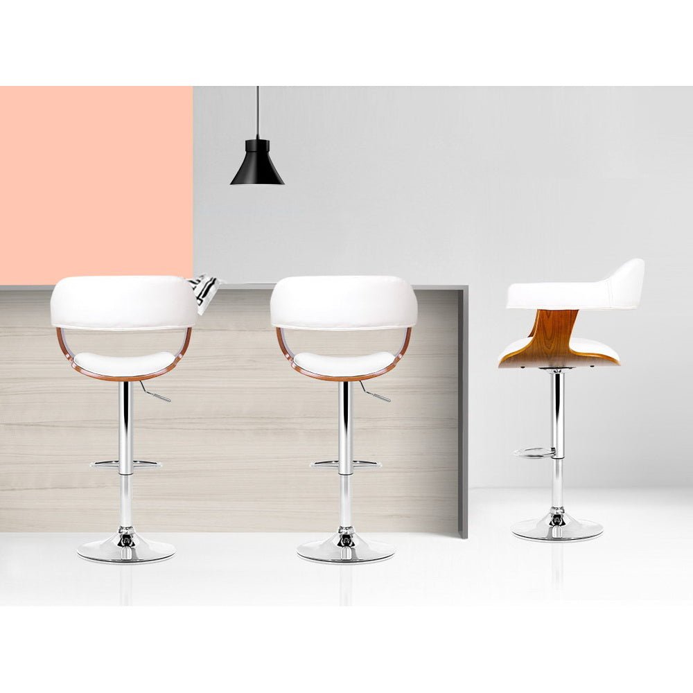 Three White Jono Adjustable Leather Bar Stools at a Kitchen Island Bench