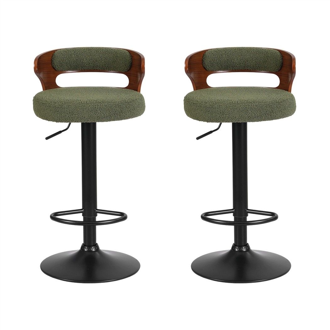 Front view of two Juna green bouclé adjustable swivel bar stools with curved walnut-look backrests and black bases.