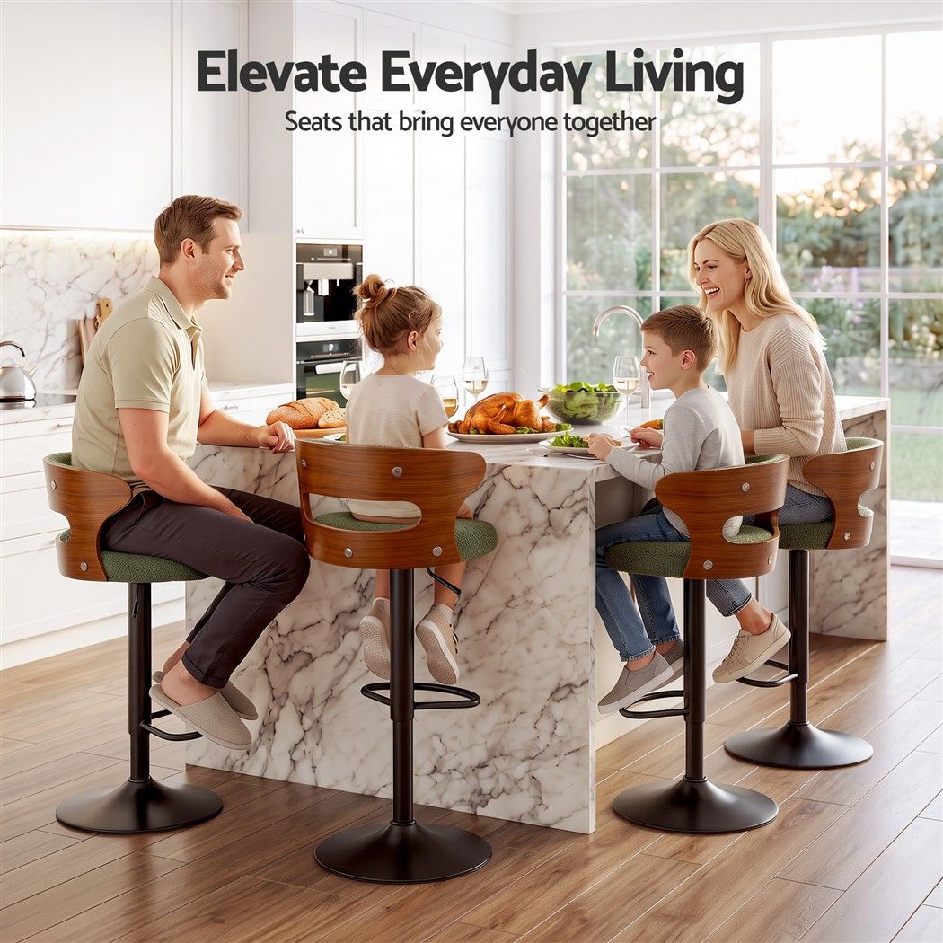 Family seated around a kitchen island on Juna green bouclé bar stools with walnut-look backrests and black pedestal bases.