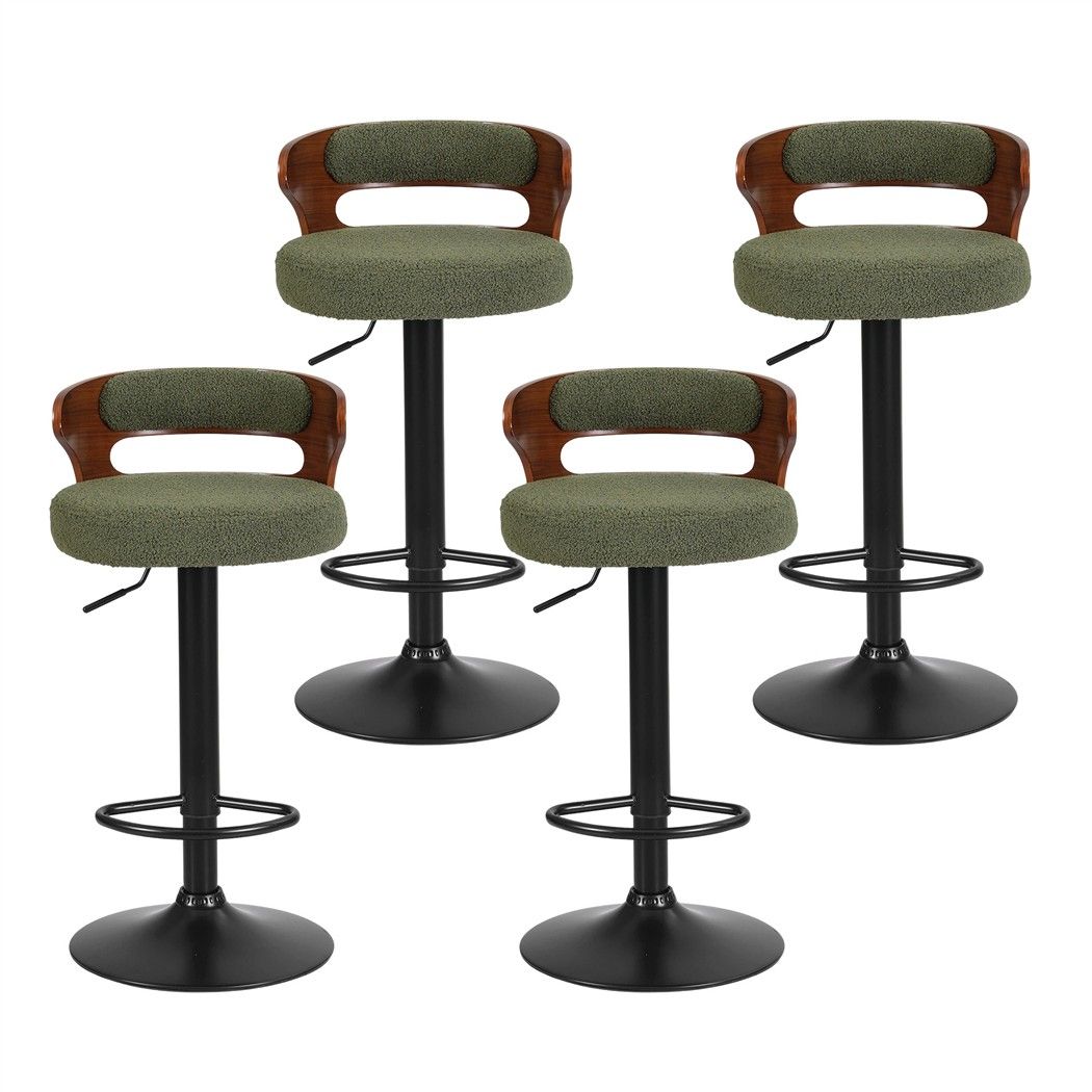 Front view of four Juna green bouclé adjustable swivel bar stools with curved walnut-look backrests and black bases.