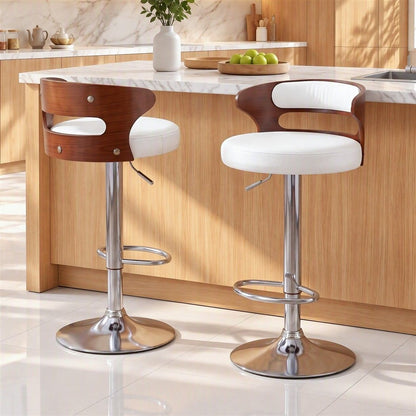 Two Juna white pu leather swivel bar stools with walnut-look backrests positioned beside a white marble kitchen island.