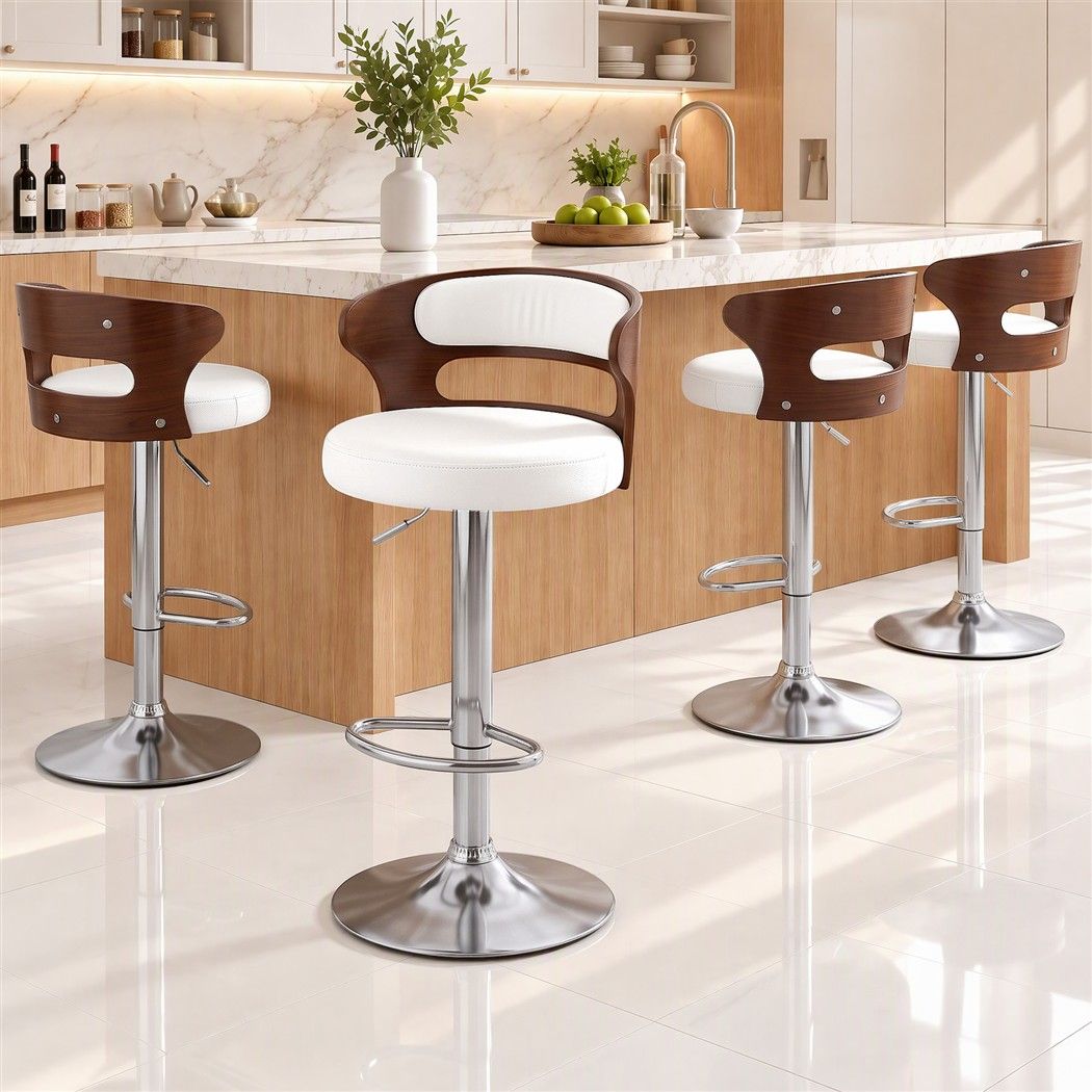 Four Juna white pu leather swivel bar stools with walnut-look backrests positioned beside a white marble kitchen island.