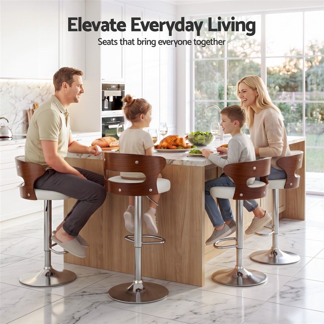 Family seated around a kitchen island on Juna white pu leather bar stools with walnut-look backrests and chrome pedestal bases.