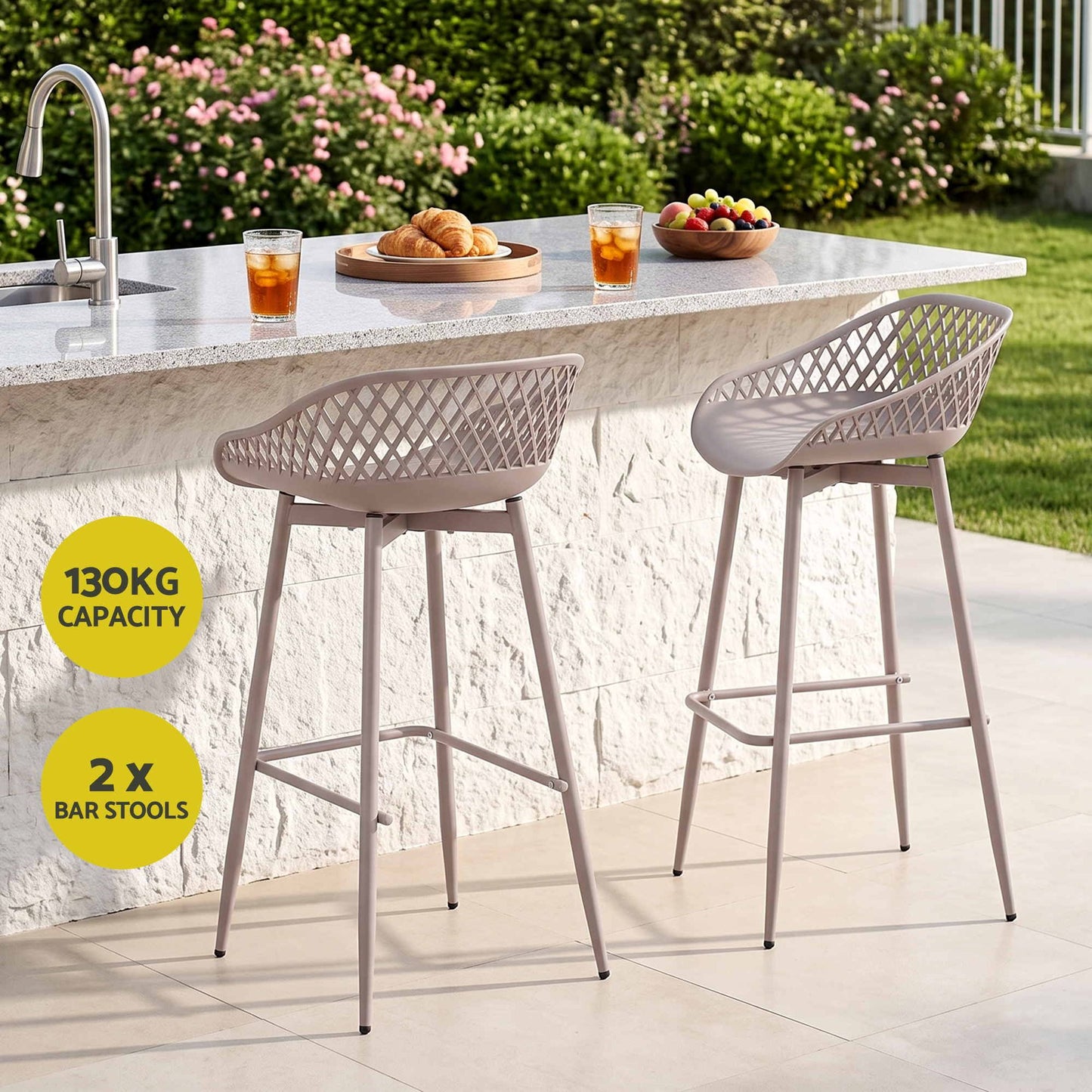 Set of two beige Kian outdoor bar stools at a stone outdoor kitchen, with 130kg weight capacity.