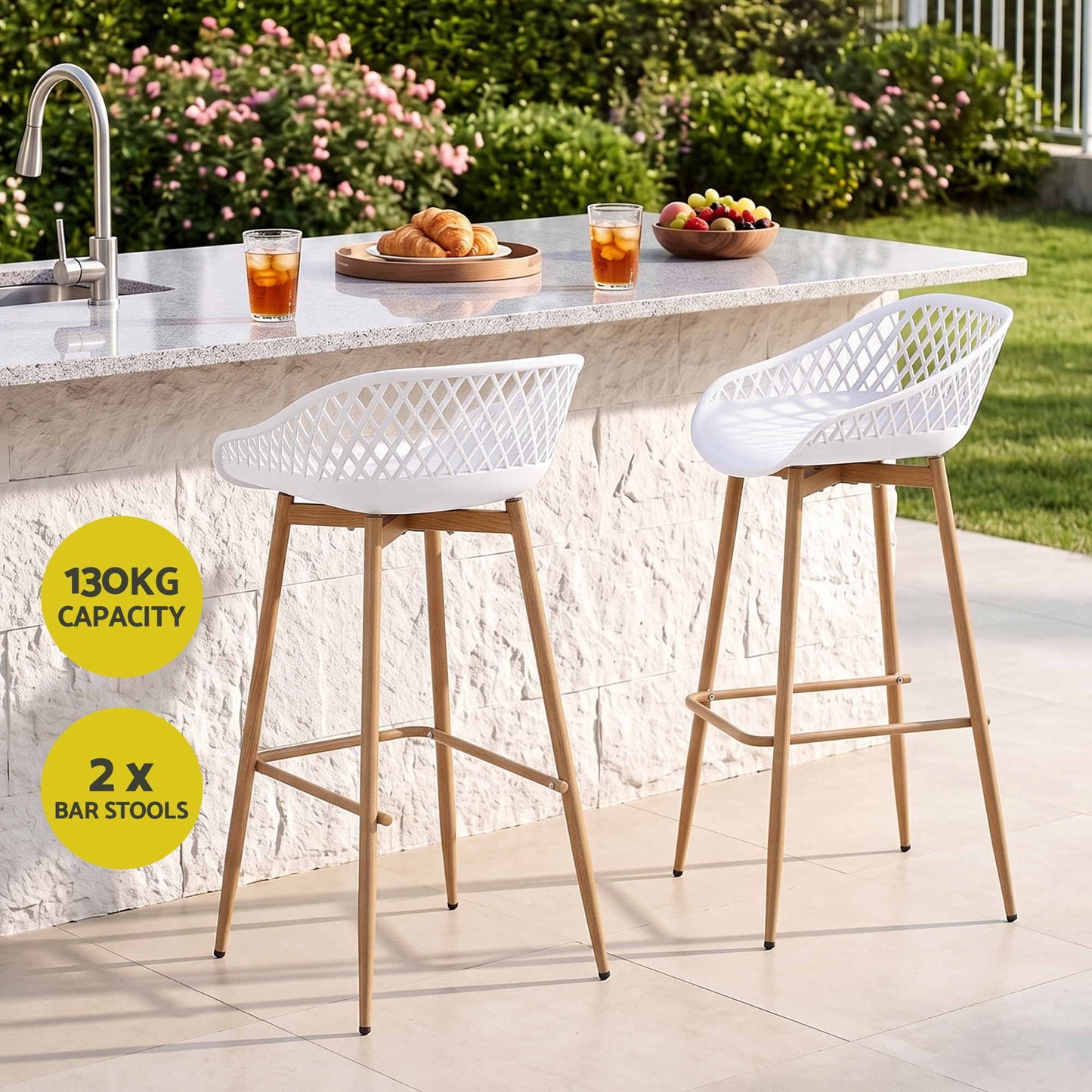 Set of two white Kian outdoor bar stools at a stone outdoor kitchen, with 130kg weight capacity.