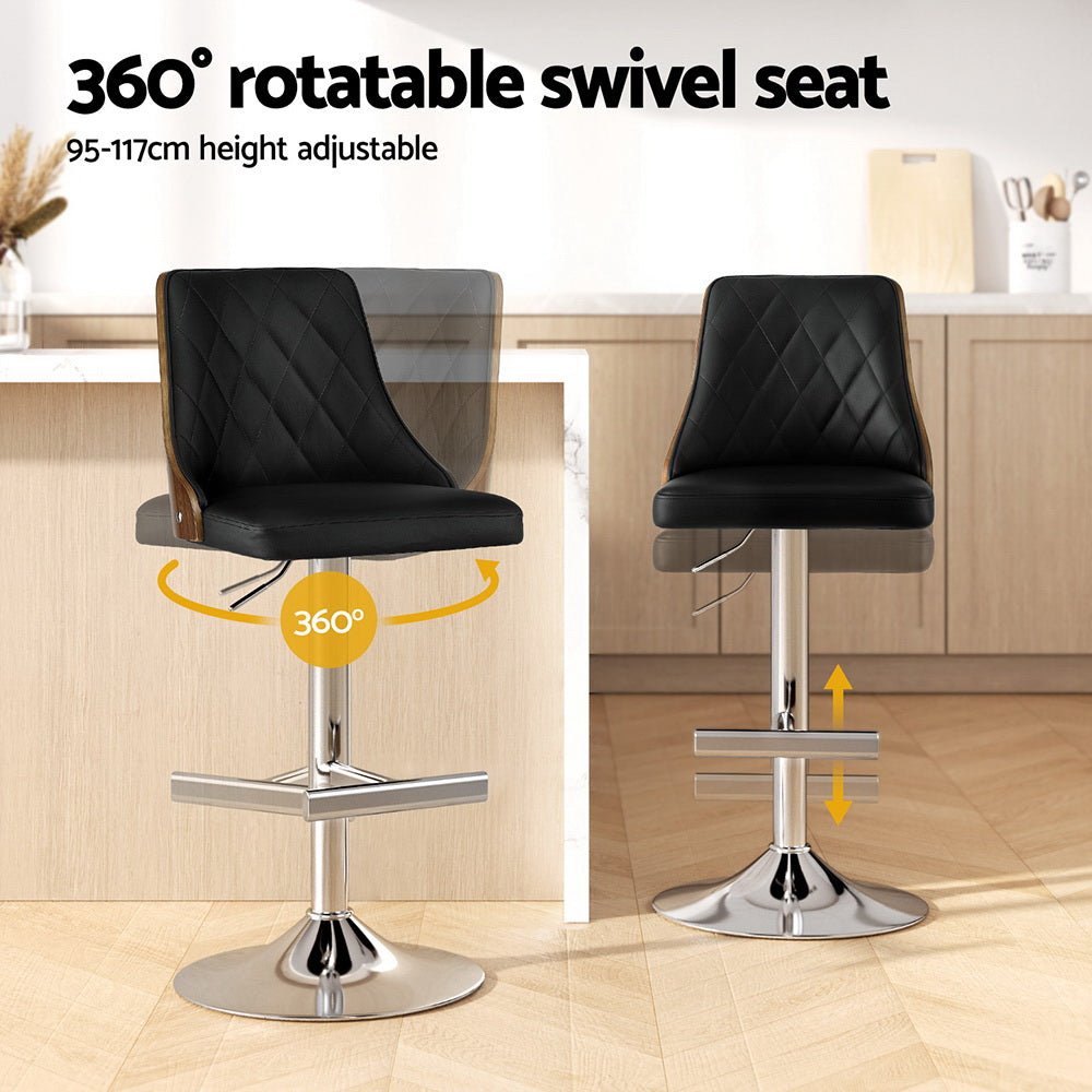 Black bar stools with 360-degree swivel seat and height adjustment in a kitchen setting.