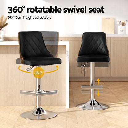 Black bar stools with 360-degree swivel seat and height adjustment in a kitchen setting.