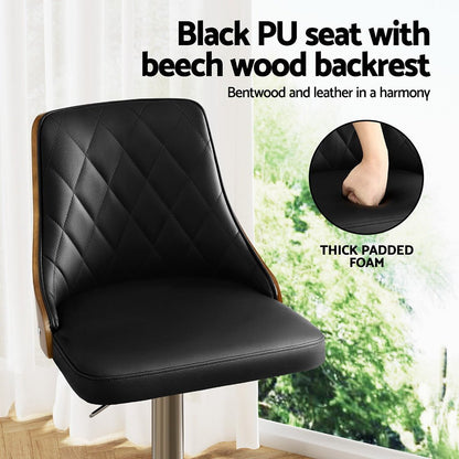 Black PU seat with beech wood backrest in a room with a window.