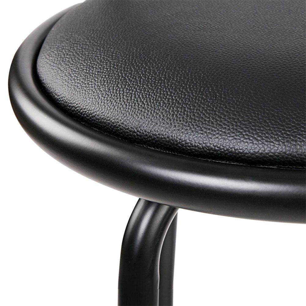 Close-up of a black stool with a textured seat on a white background