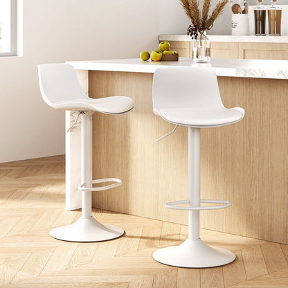 Two white swivel bar stools in front of a kitchen counter with a light wood floor.