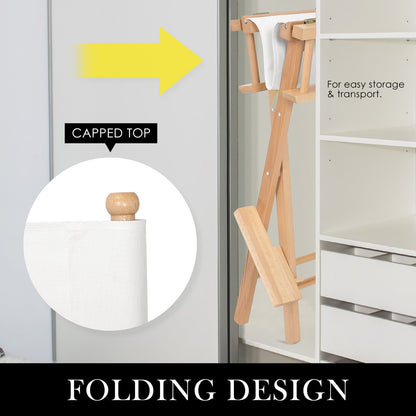 Folding beechwood Oxford director chair with capped top detail, shown stored beside a wardrobe for easy storage and transport. Labeled “Folding Design”
