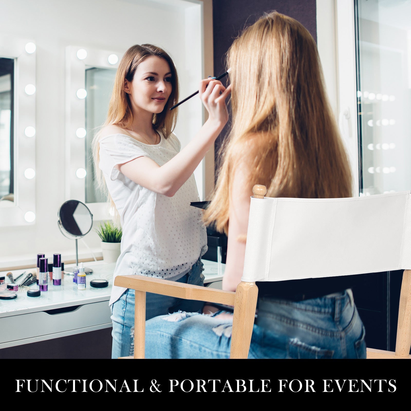 Makeup artist applying makeup to a client seated on a wooden Oxford tall director chair with white canvas seat and backrest in a bright studio setting.