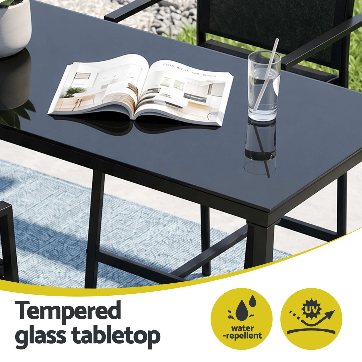 Black glass table with a newspaper and glass of water, featuring water-repellent and scratch-resistant icons.
