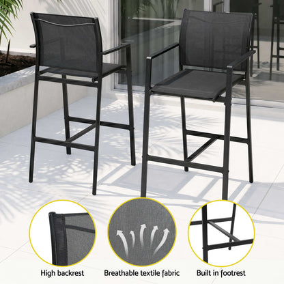 Two black outdoor bar stools with high backrest, breathable textile fabric, and built-in footrest on a patio.