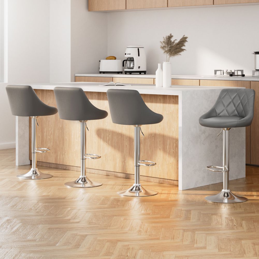 Modern kitchen with grey bar stools and a white island.