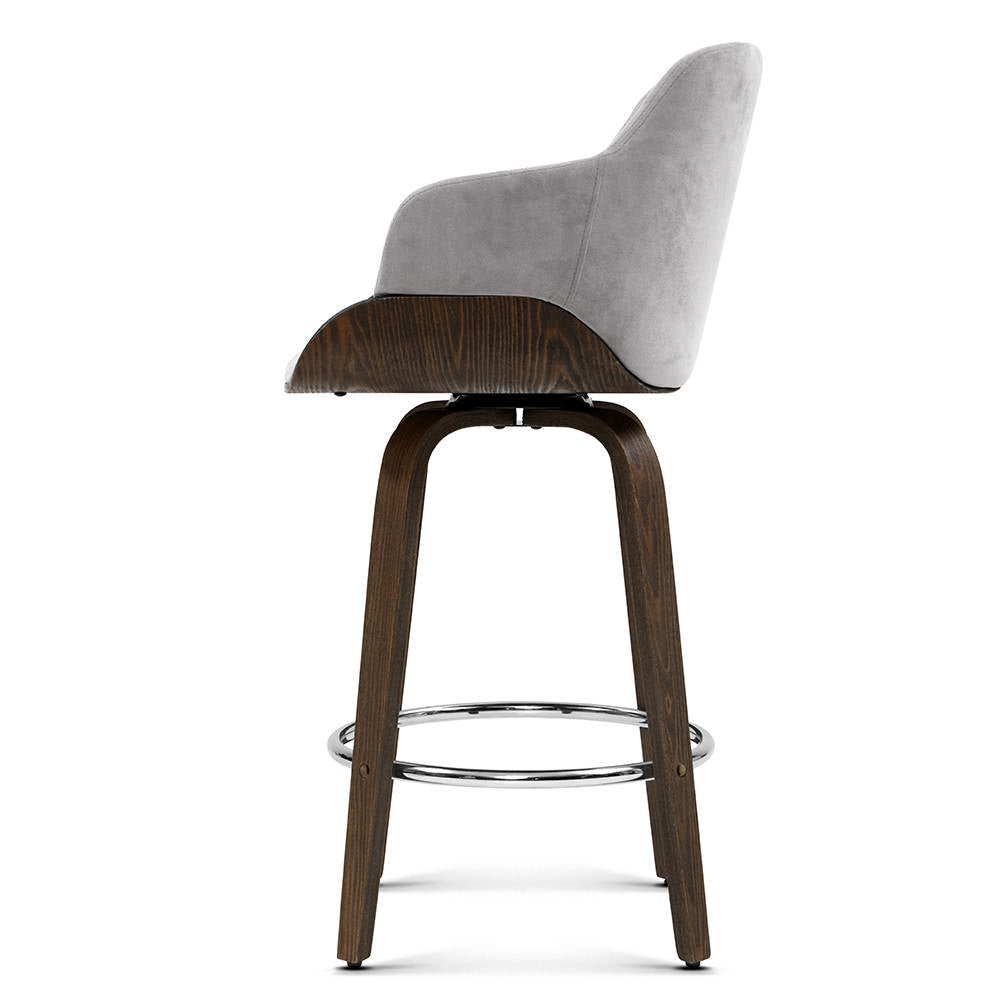 Side profile of the grey Remi 70cm velvet swivel bar stool with timber legs and chrome footrests