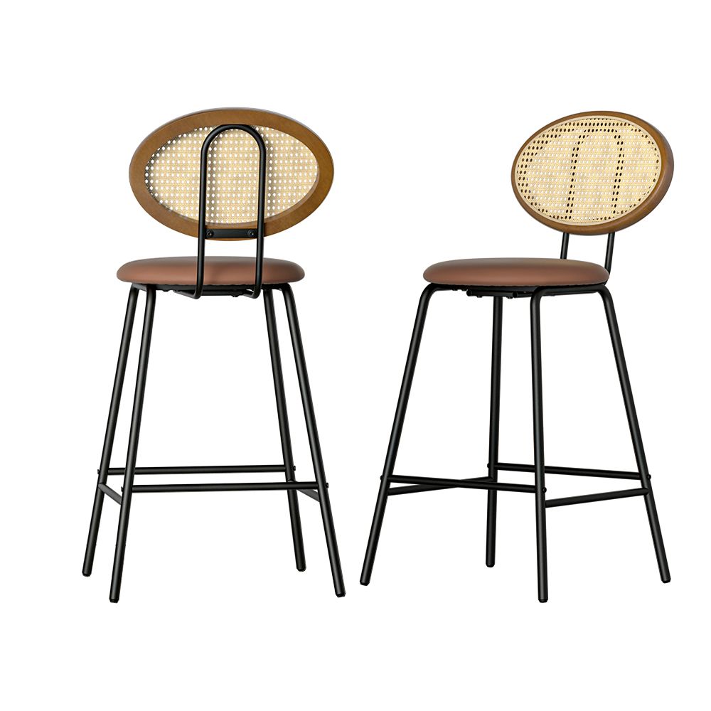 Two bar stools with wicker backrests and brown leather seats on a white background