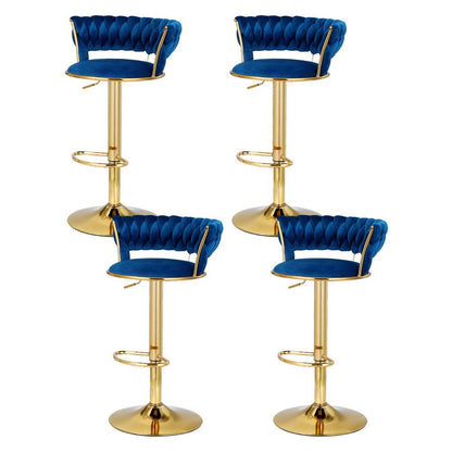 Four Sola adjustable velvet swivel bar stools in navy blue with tufted backs, gold-toned pedestal bases and footrests.