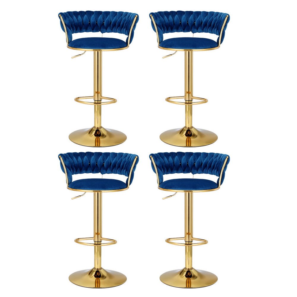 Four Sola adjustable velvet swivel bar stools in navy blue with tufted backs, gold-toned pedestal bases and footrests.