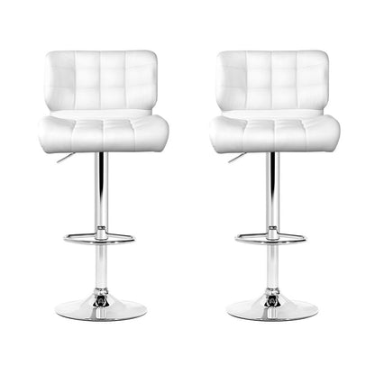 Two white bar stools with quilted design on a white background