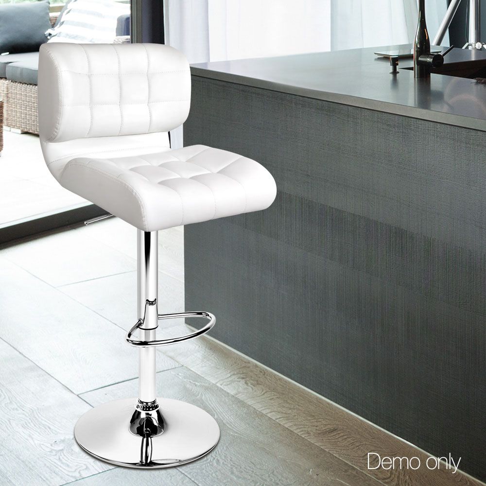 White leather bar stool in a modern kitchen setting with a dark countertop.