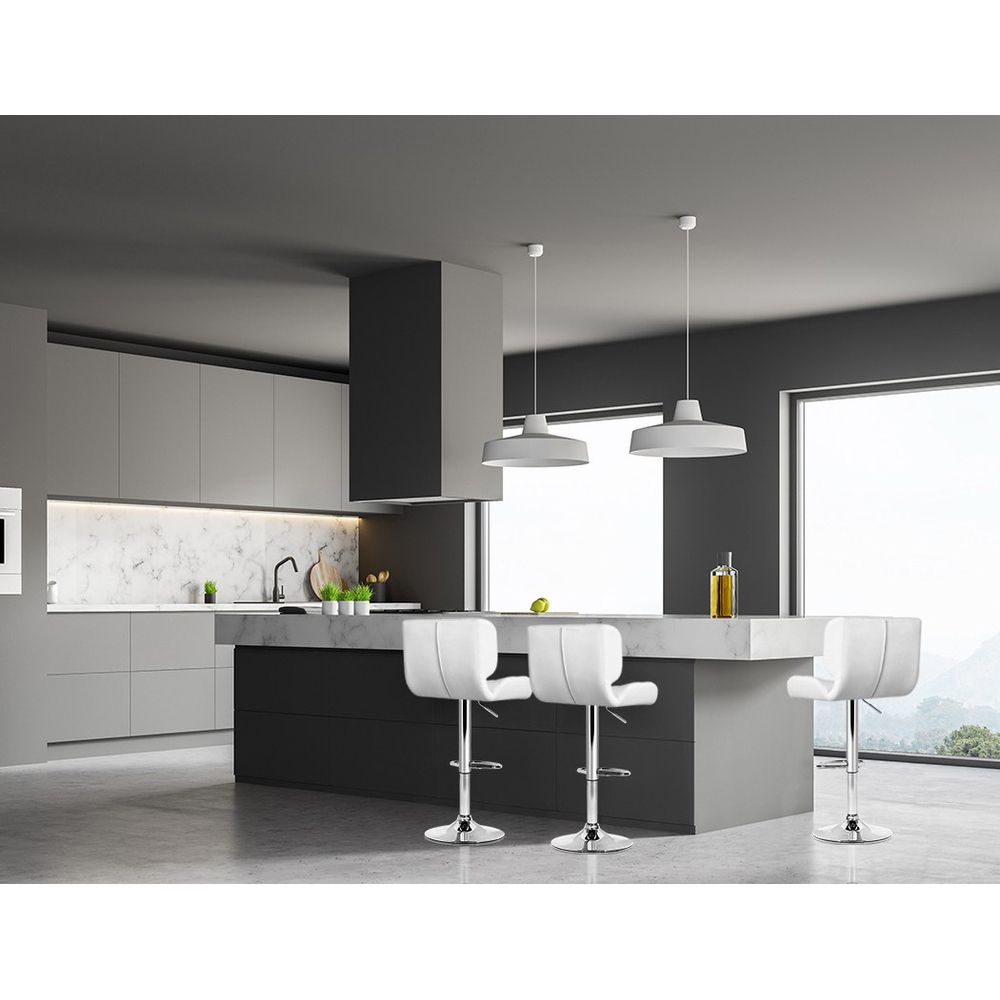 Modern kitchen with grey cabinets, white countertops, and white bar stools.